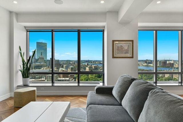 a living room with a large window and a couch
