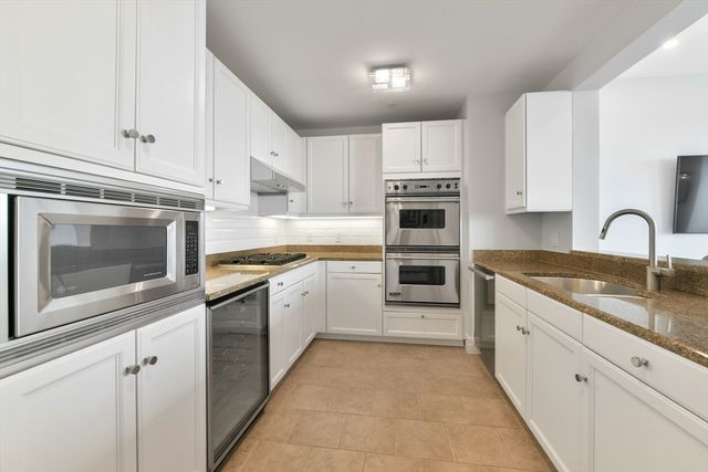a kitchen with cabinets appliances and a sink
