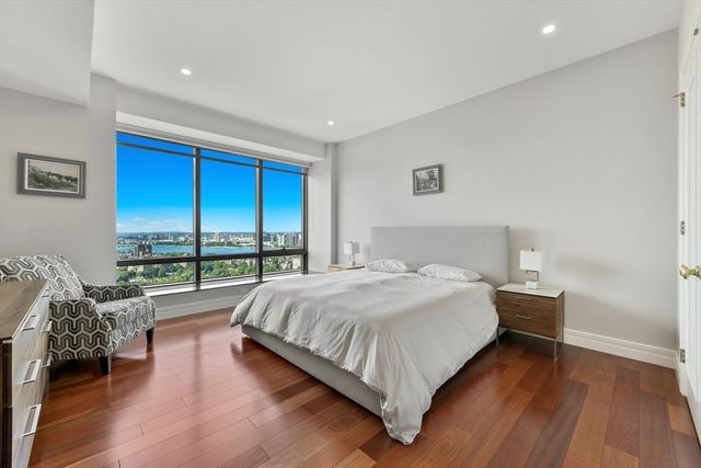 a bedroom with a bed and a large window