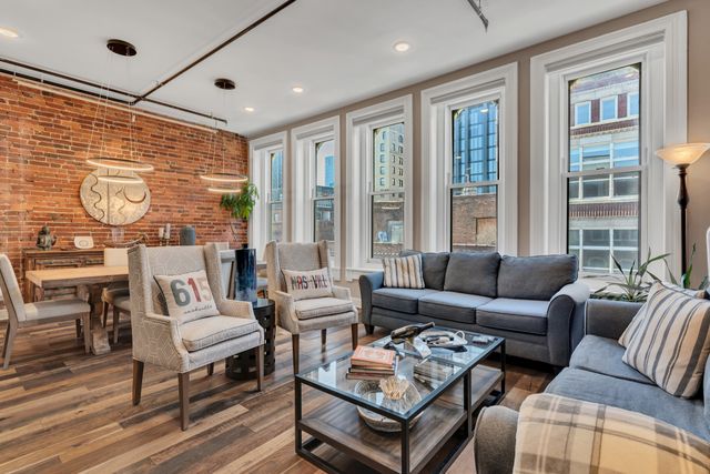 a view of a hallway with workspace and a window