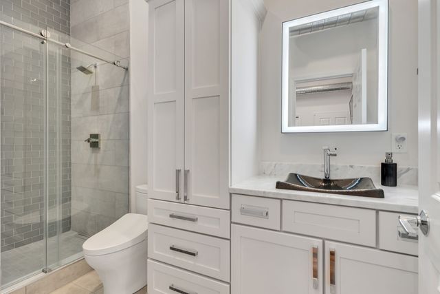 a bathroom with a toilet and shower