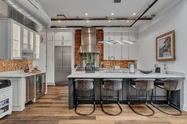 a kitchen with granite countertop a stove and a sink