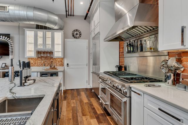 a kitchen with sink stove and cabinets