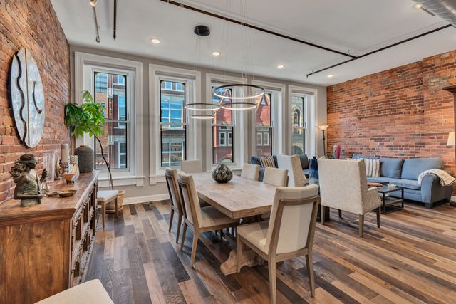 a dining room with furniture and wooden floor