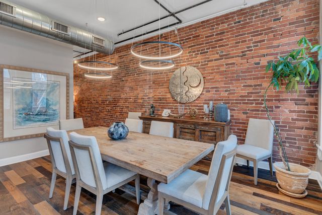 a view of a dining room with furniture wooden floor and chandelier