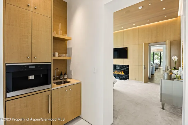 a living room with furniture large window and a fireplace
