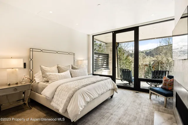 a bathroom with a granite countertop toilet sink and mirror