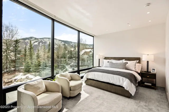 a bedroom with a bed and a lamp