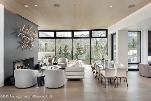 a living room with fireplace furniture and a large window