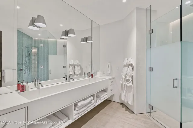 a view of a patio with table and chairs under an umbrella