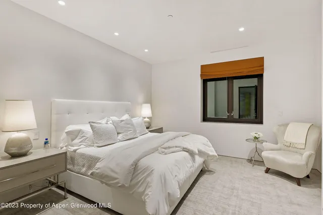 a patio with a table and chairs under an umbrella