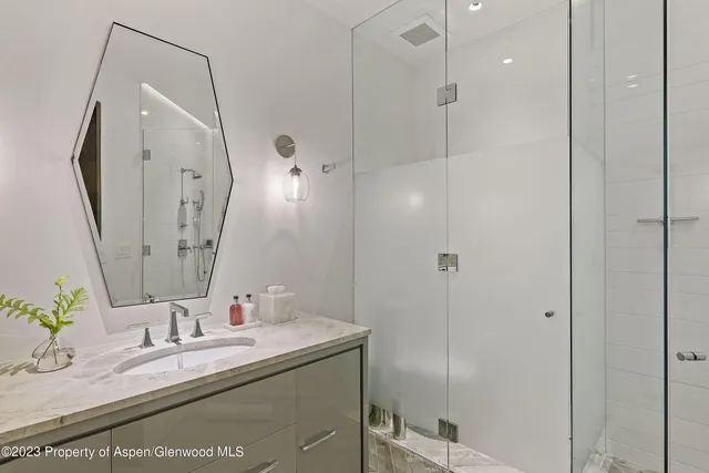 a roof deck with couch and potted plants