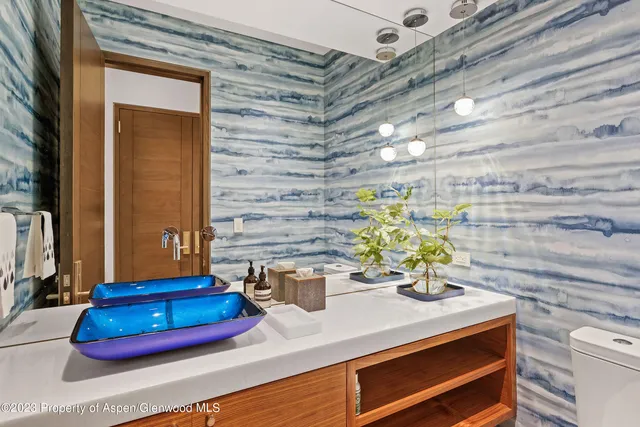 a view of a patio with couches table and chairs under an umbrella