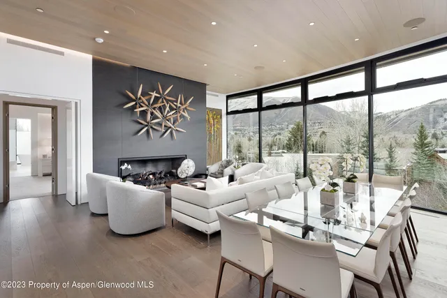 a bedroom with a bed a flat screen tv and a fireplace