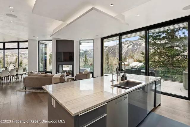 a bathroom with a granite countertop sink a mirror a bathtub and shower