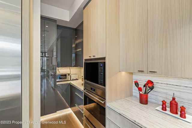 a spacious bathroom with a double vanity sink a large mirror and a bathtub