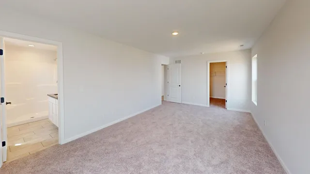 a view of an empty room and a window