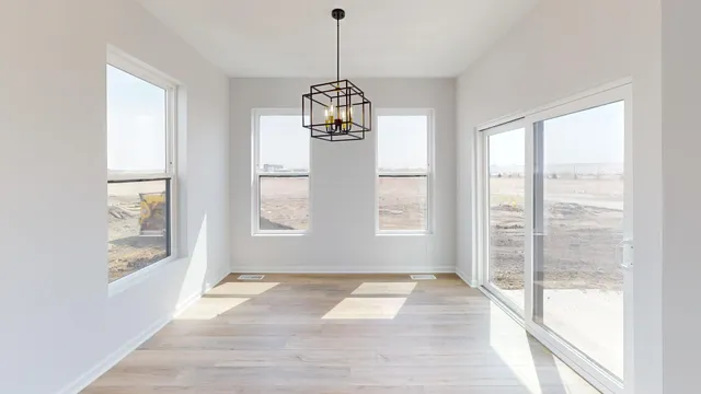 a view of a room with wooden floor and windows