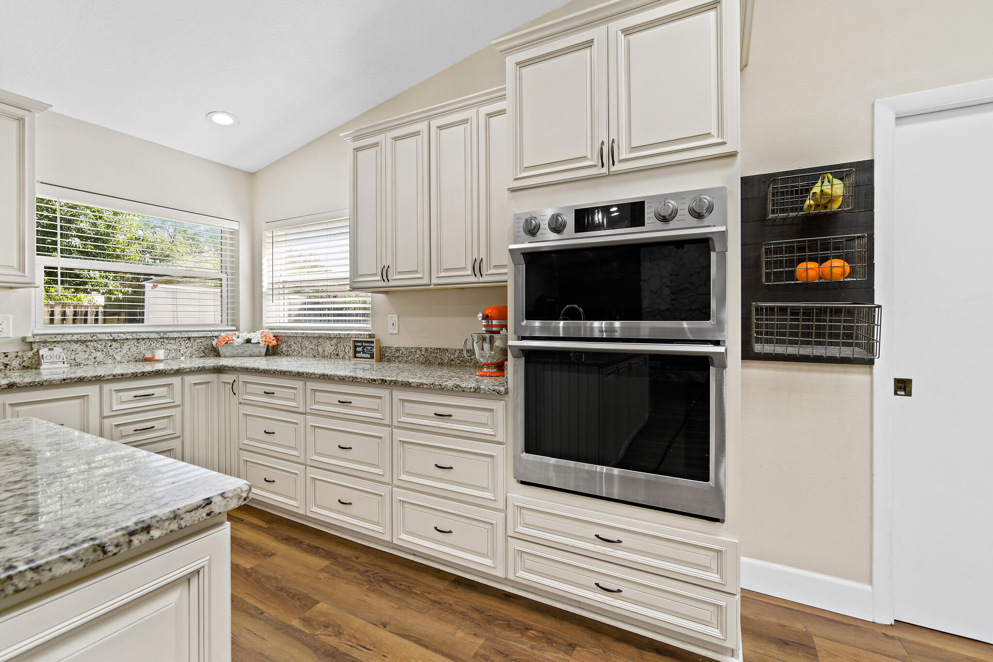 810 Knecht Road Northeast Palm Bay, FL 32905 - Photo 25 of 63 a kitchen with granite countertop white cabinets stainless steel appliances and window