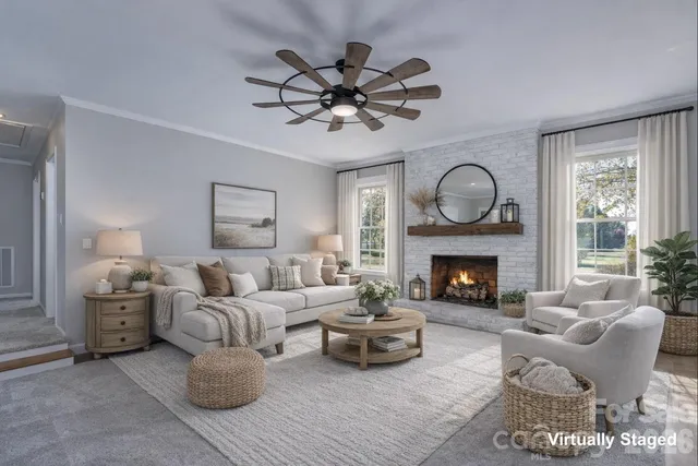 a living room with furniture a fireplace and window
