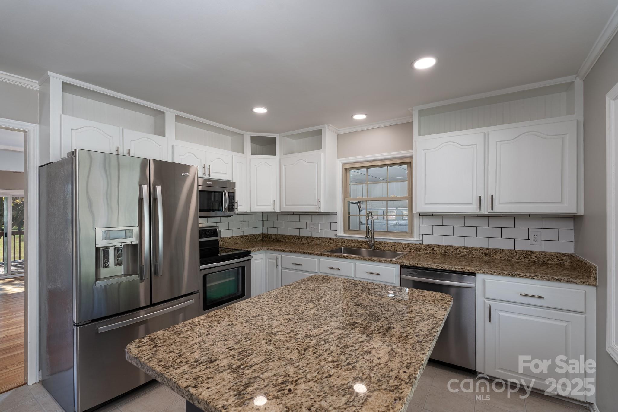 3105 West Zion Church Road Shelby, NC 28150 - Photo 13 of 44 a kitchen with a refrigerator sink and cabinets