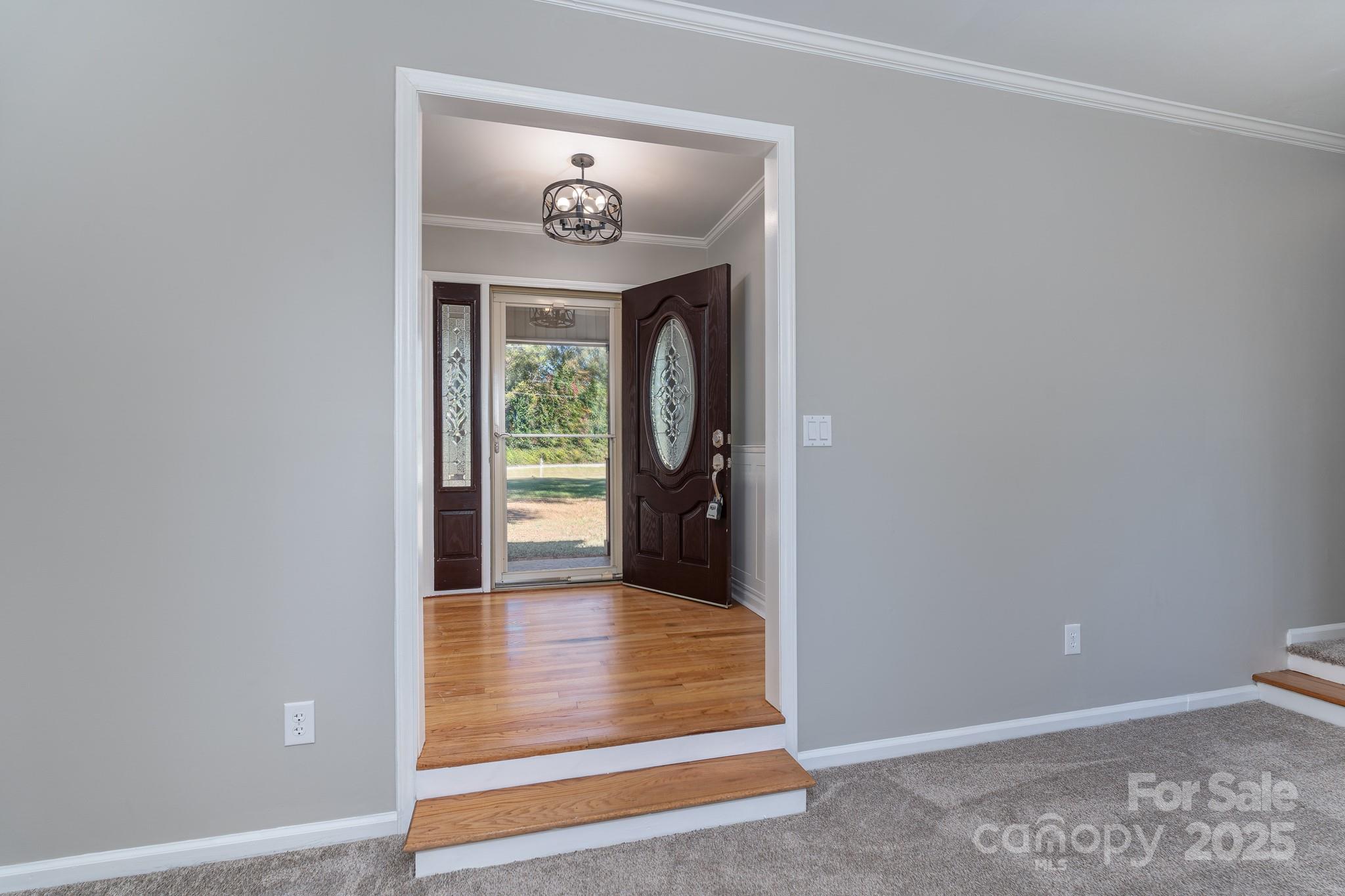 3105 West Zion Church Road Shelby, NC 28150 - Photo 6 of 44 a view of a hallway with wooden floor and a large window