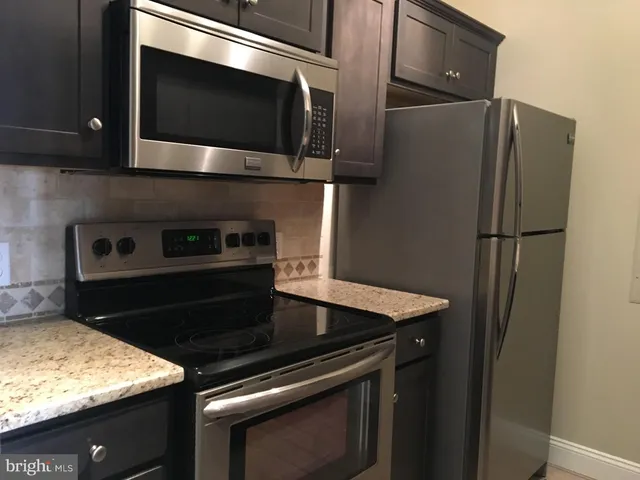 a kitchen with a stove microwave and refrigerator