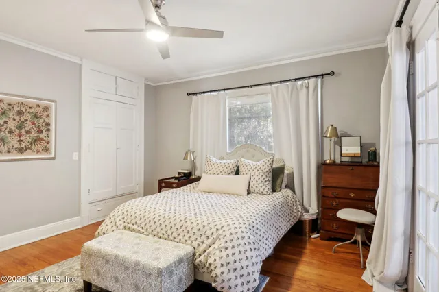 a bedroom with a bed and wooden floor