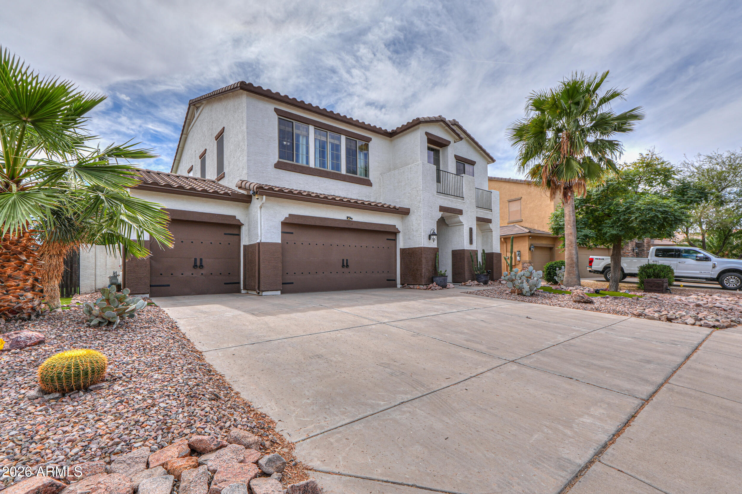 45247 West Jack Rabbit Trail Maricopa, AZ 85139 - Photo 4 of 75 a front view of a house with garden