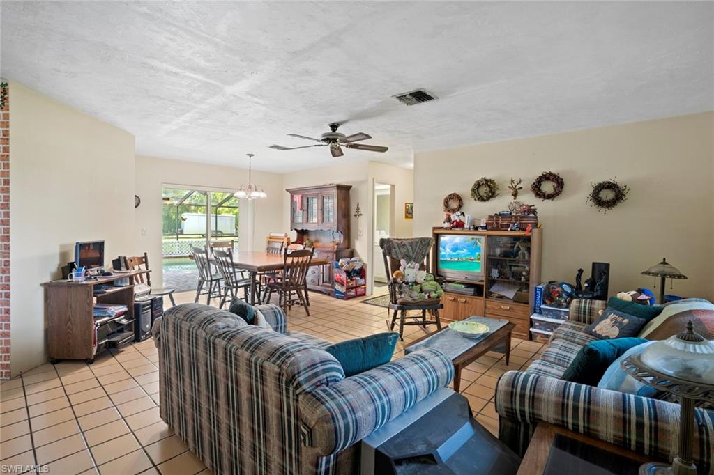 20599 Charing Cross Circle Estero, FL 33928 - Photo 3 of 24 a living room with furniture and a flat screen tv