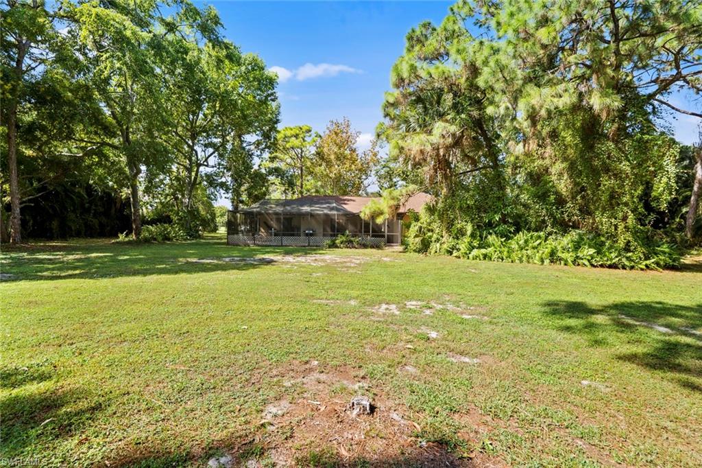 20599 Charing Cross Circle Estero, FL 33928 - Photo 24 of 24 a view of a swimming pool with a yard