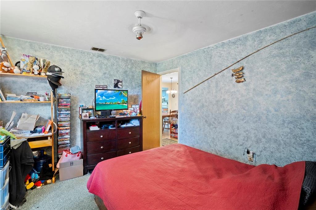 20599 Charing Cross Circle Estero, FL 33928 - Photo 8 of 24 a bedroom with a bed and a walk in closet