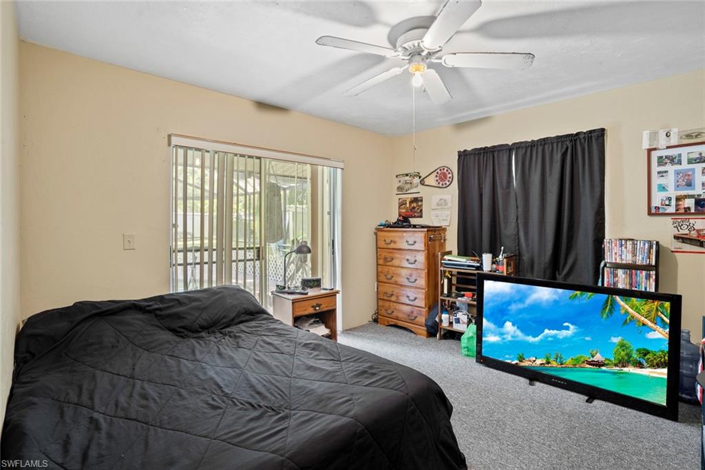 20599 Charing Cross Circle Estero, FL 33928 - Photo 10 of 24 a bedroom with a bed flat screen tv and a window