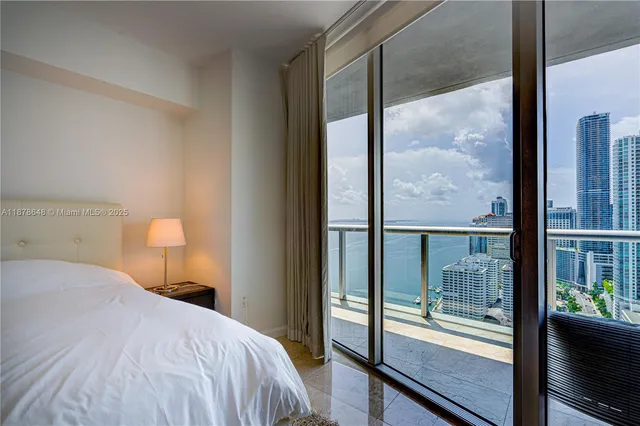 a bedroom with a large bed and a large window