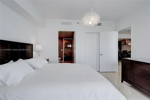 a bedroom with a bed and a television