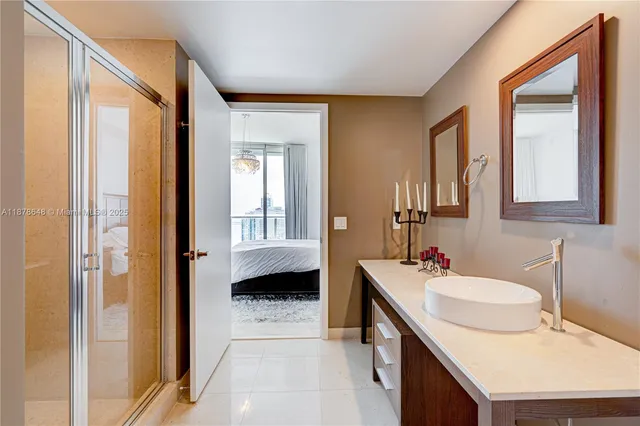 a en suite bathroom with a sink double vanity and a mirror