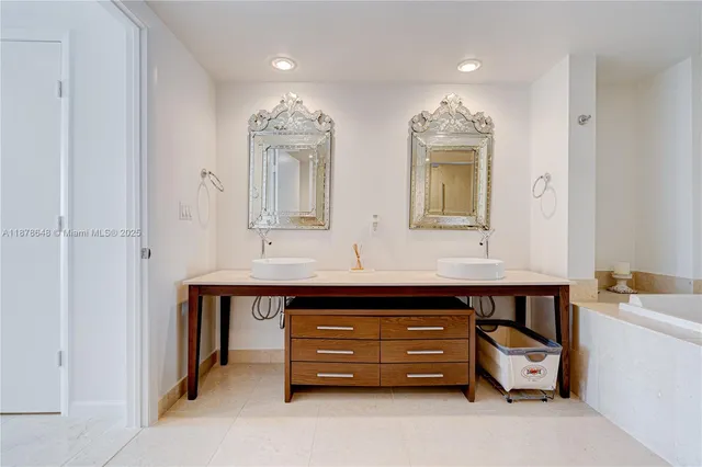 a spacious bathroom with a double vanity sink and a mirror