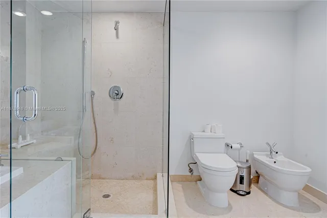 a bathroom with a toilet sink and shower