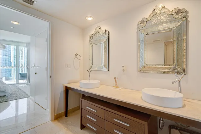 a bathroom with a sink double vanity and a mirror