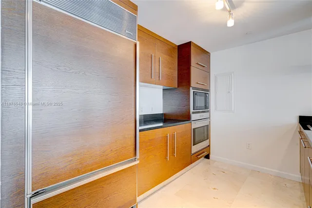 a kitchen with stainless steel appliances granite countertop a refrigerator and a stove