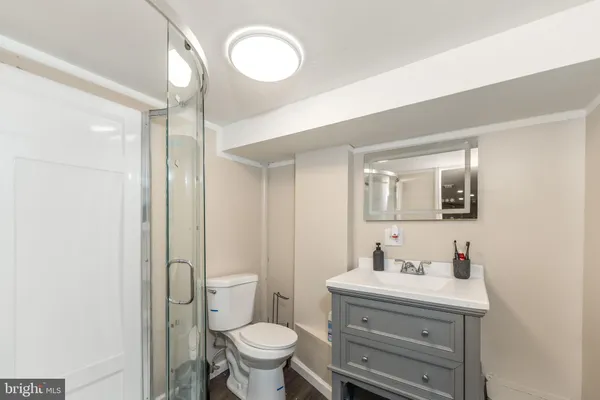 a bathroom with a sink mirror vanity and toilet
