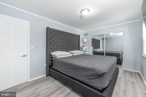 a bedroom with a bed and a mirror