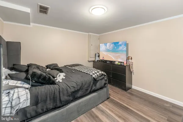 a bedroom with a bed and a painting on the wall