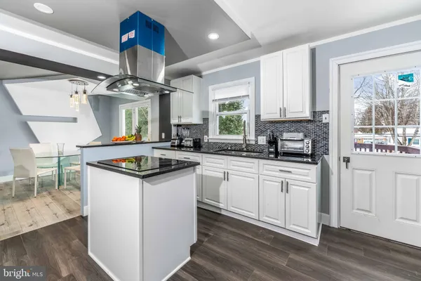 a kitchen with stainless steel appliances granite countertop a sink a stove and a refrigerator