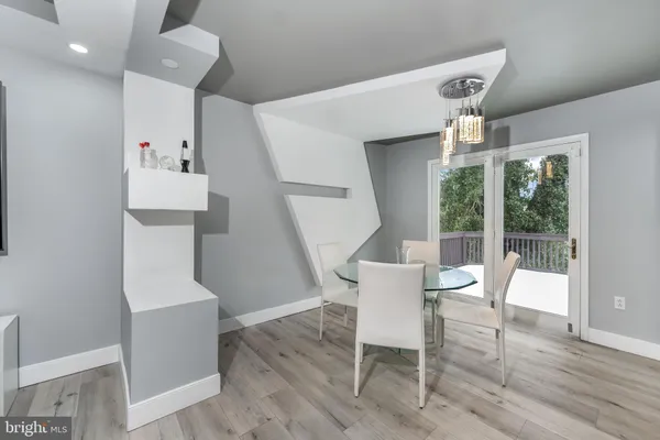 a dining room with furniture and wooden floor