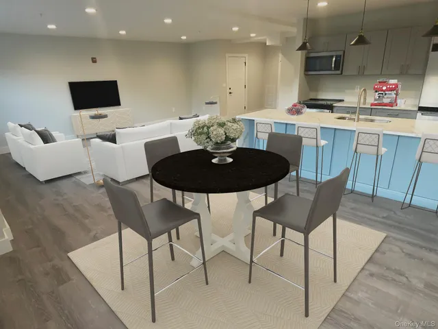 a kitchen with a dining table chairs and white cabinets