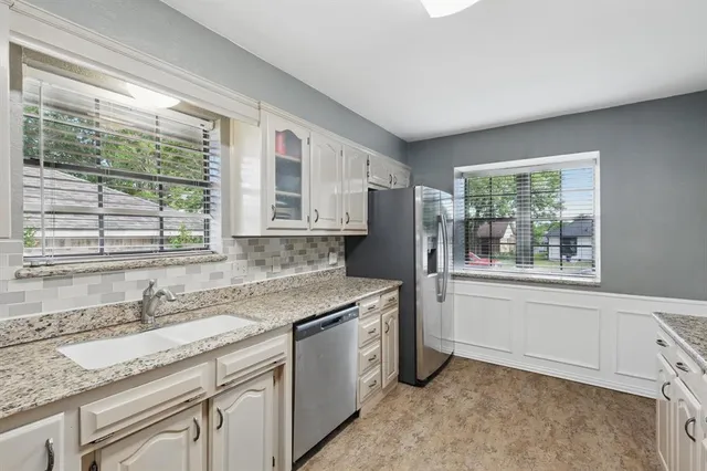 a kitchen with a sink stove and cabinets
