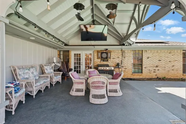a dining room with furniture and a floor to ceiling window