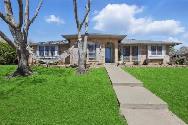 a front view of a house with a yard table and chairs