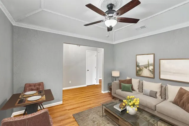 a living room with furniture and wooden floor